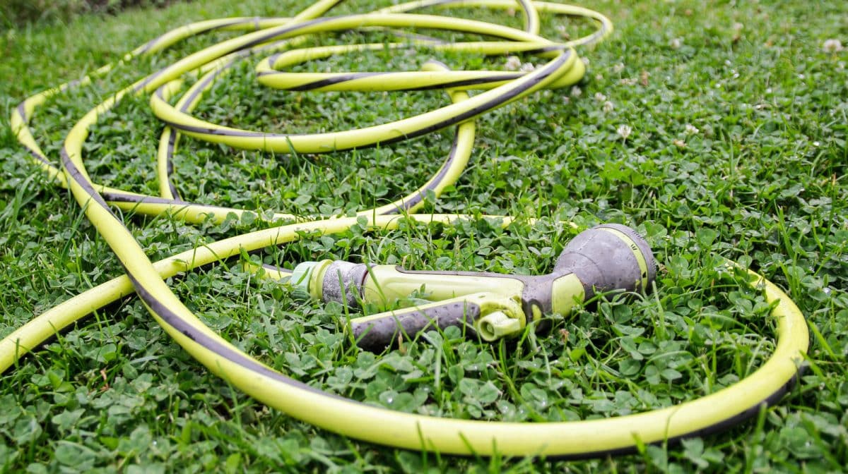 Say Goodbye To Garden Hose And Cord Clutter With One Simple Storage Hack