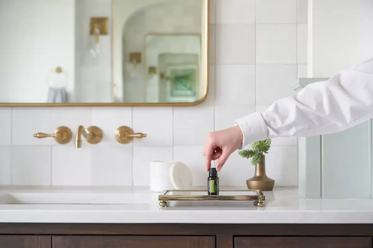 Clear organizer with compartments holding hair clips and pins on a bathroom counter