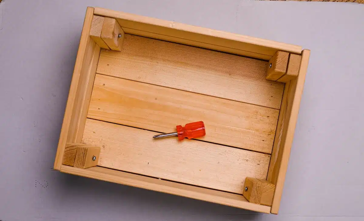Deck box with faux wood-grain finish complementing a traditional deck aesthetic