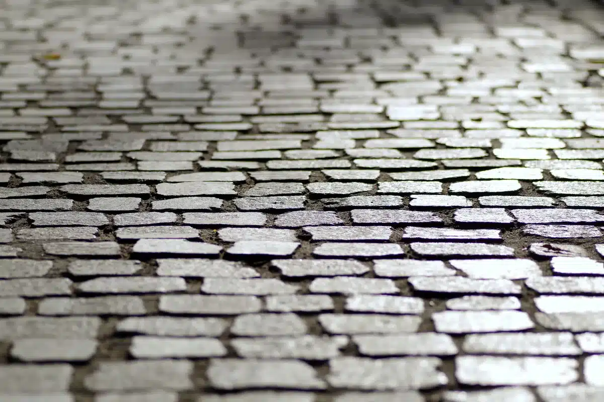 Traditional cobblestone or brick driveway with textured surface and pattern