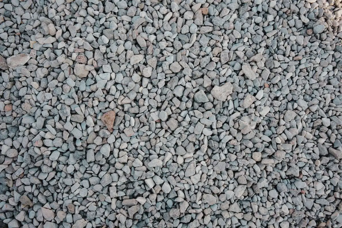 Cross-section view of a gravel driveway showing layered aggregate materials and proper compaction