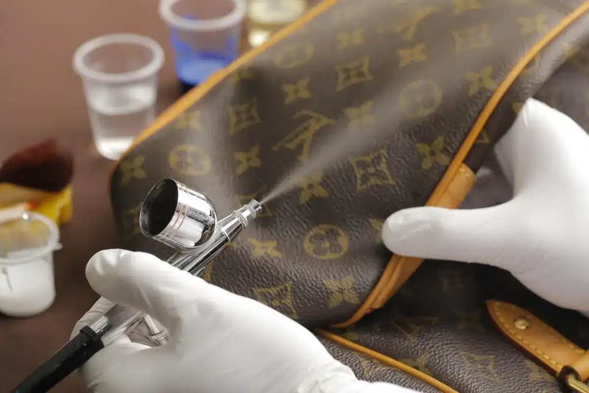 Close-up of a stain being treated with cleaning solution on fabric before washing