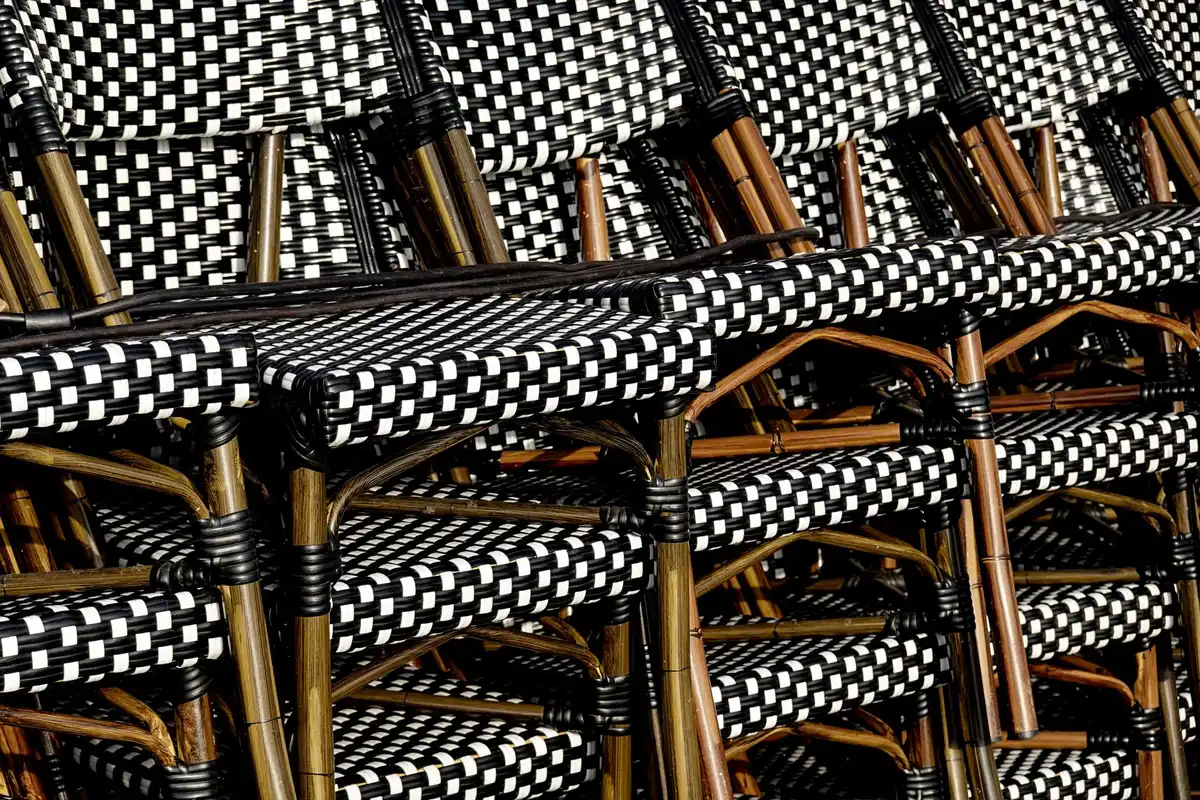 Folded wooden bistro table and chairs stored compactly in a narrow space