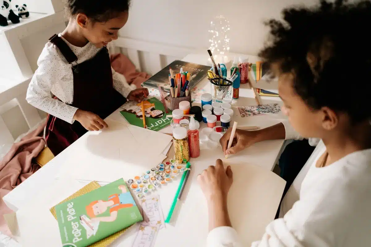 Array of craft materials including markers, paint, glue, and LED lights for bottle decoration