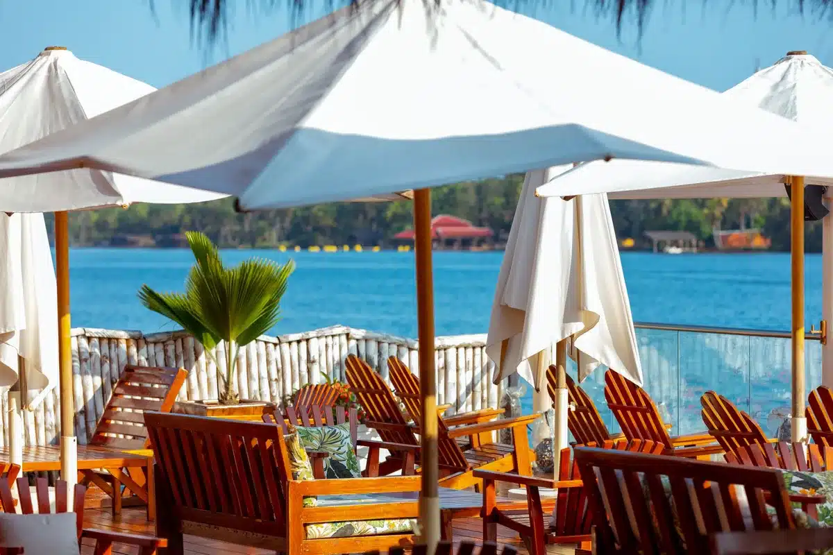 Large offset umbrella shading a lounge chair and side table on a sunny patio