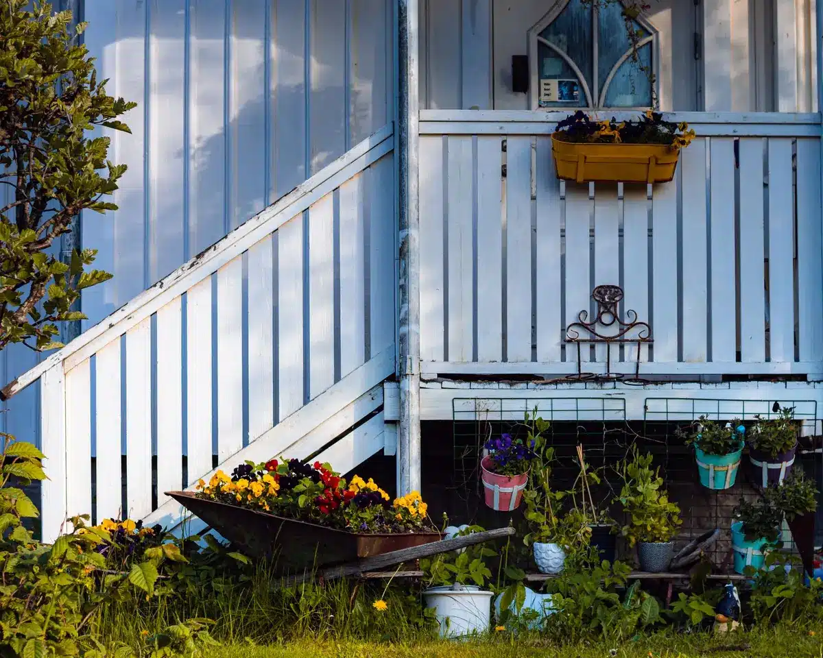 Decorative DIY dragonflies hanging from porch beams and displayed in garden planters