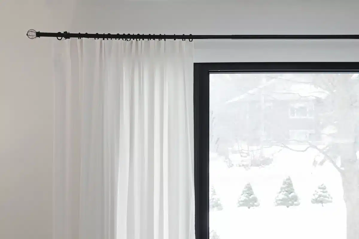 Renter-friendly curtain hanging methods including tension rods and clip rings on a standard rod