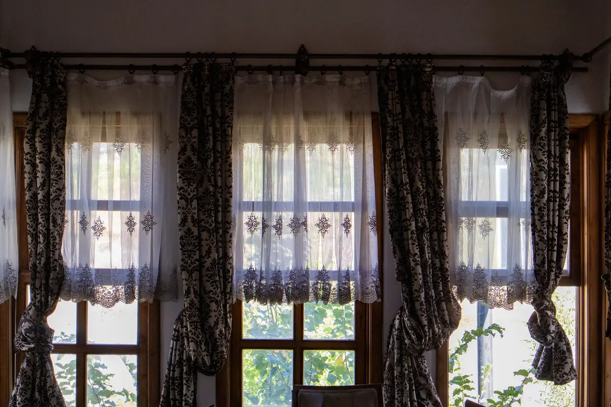 Vintage flour-sack fabric with bold printed design displayed flat as window covering to showcase the pattern