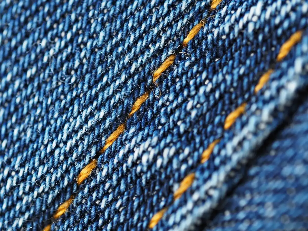 Close-up of outdoor fabric with metal grommets and stitching on a balcony panel
