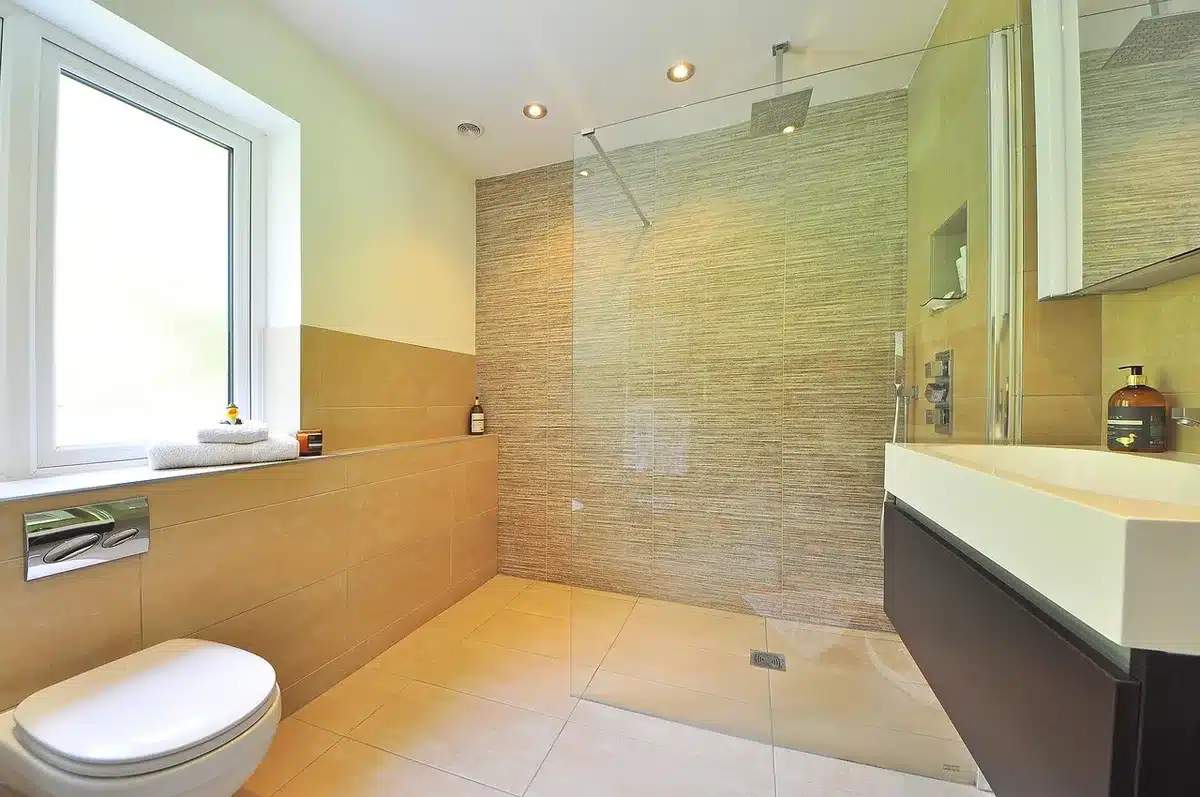 Woven egg basket filled with rolled towels displayed on a bathroom vanity