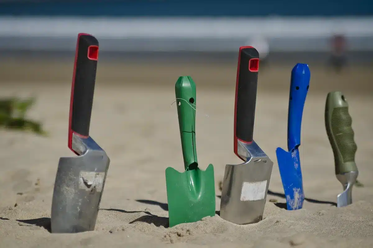 DIY tile tools laid out: tape measure, level, trowel, spacers, and chalk line