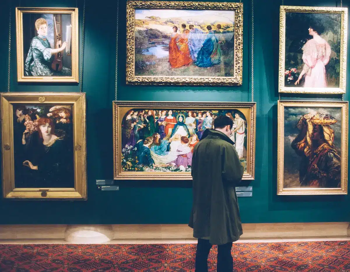Multiple framed artworks arranged in a gallery-style grouping on a neutral wall
