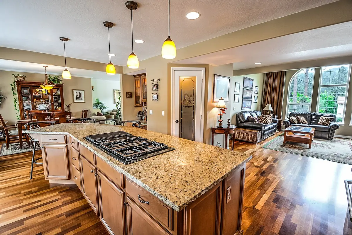 Designer discussing kitchen layout and cabinet options with homeowner at a table with blueprints