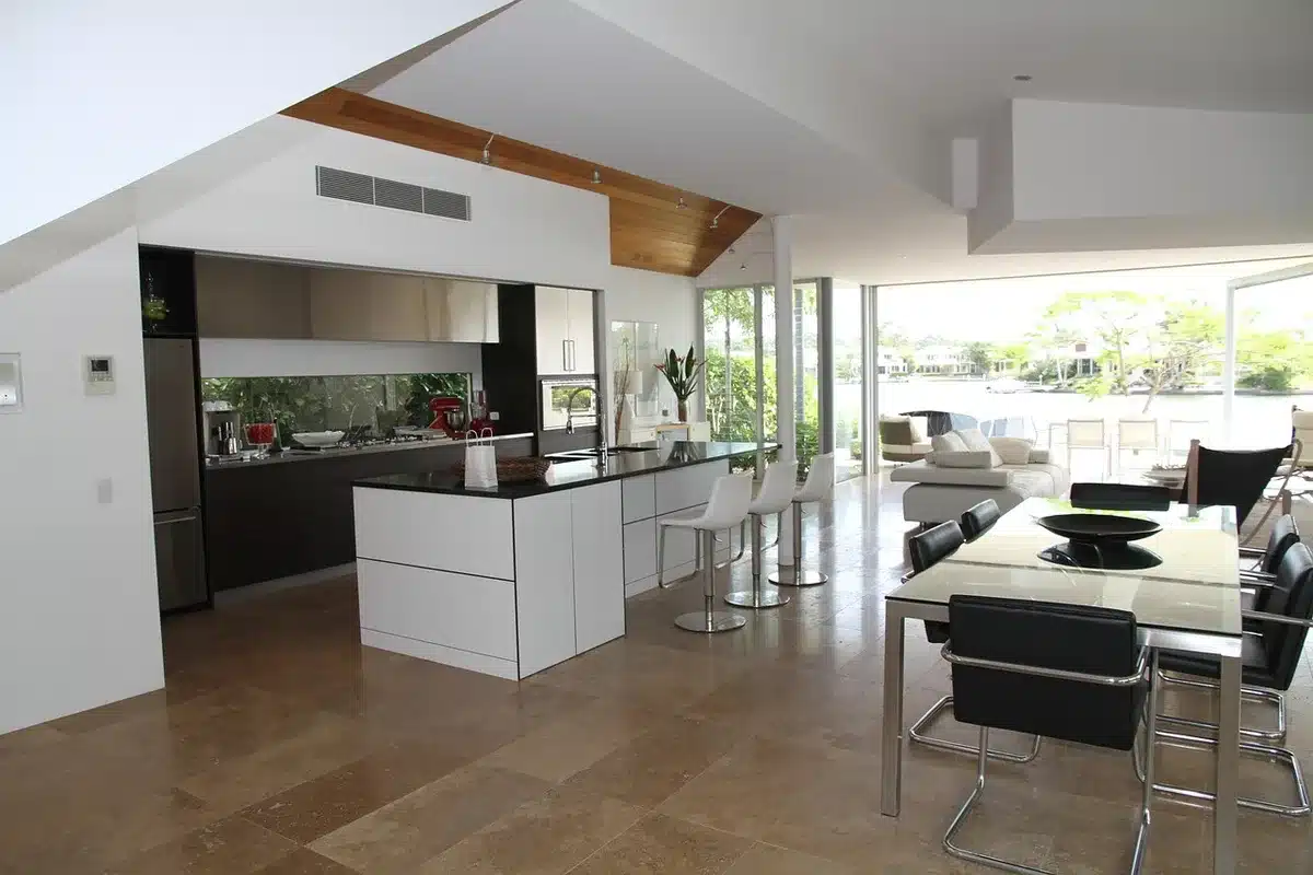Wall-mounted rail displaying folded and draped throws in a bright living room