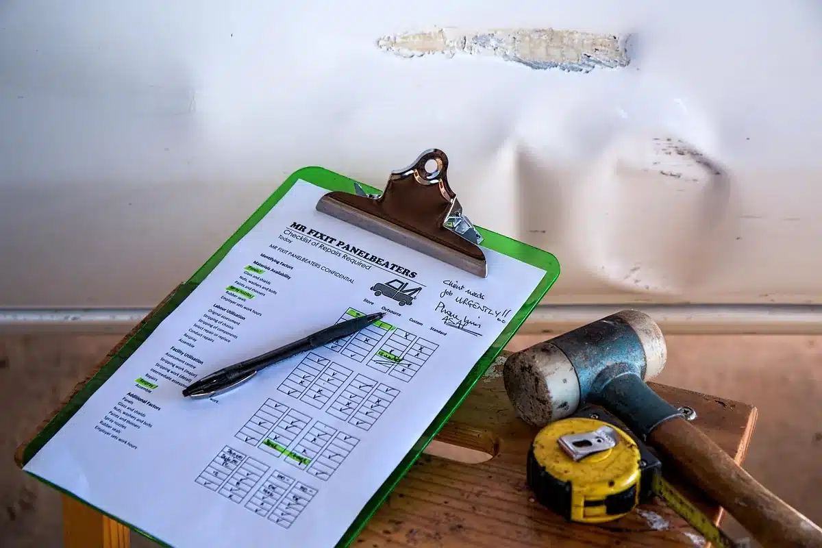 Homeowner reviewing driveway cost estimates and contractor quotes on a table