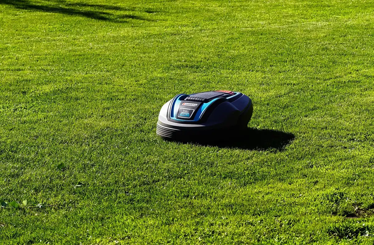 Self-propelled electric battery-powered lawn mower on grass with foldable design