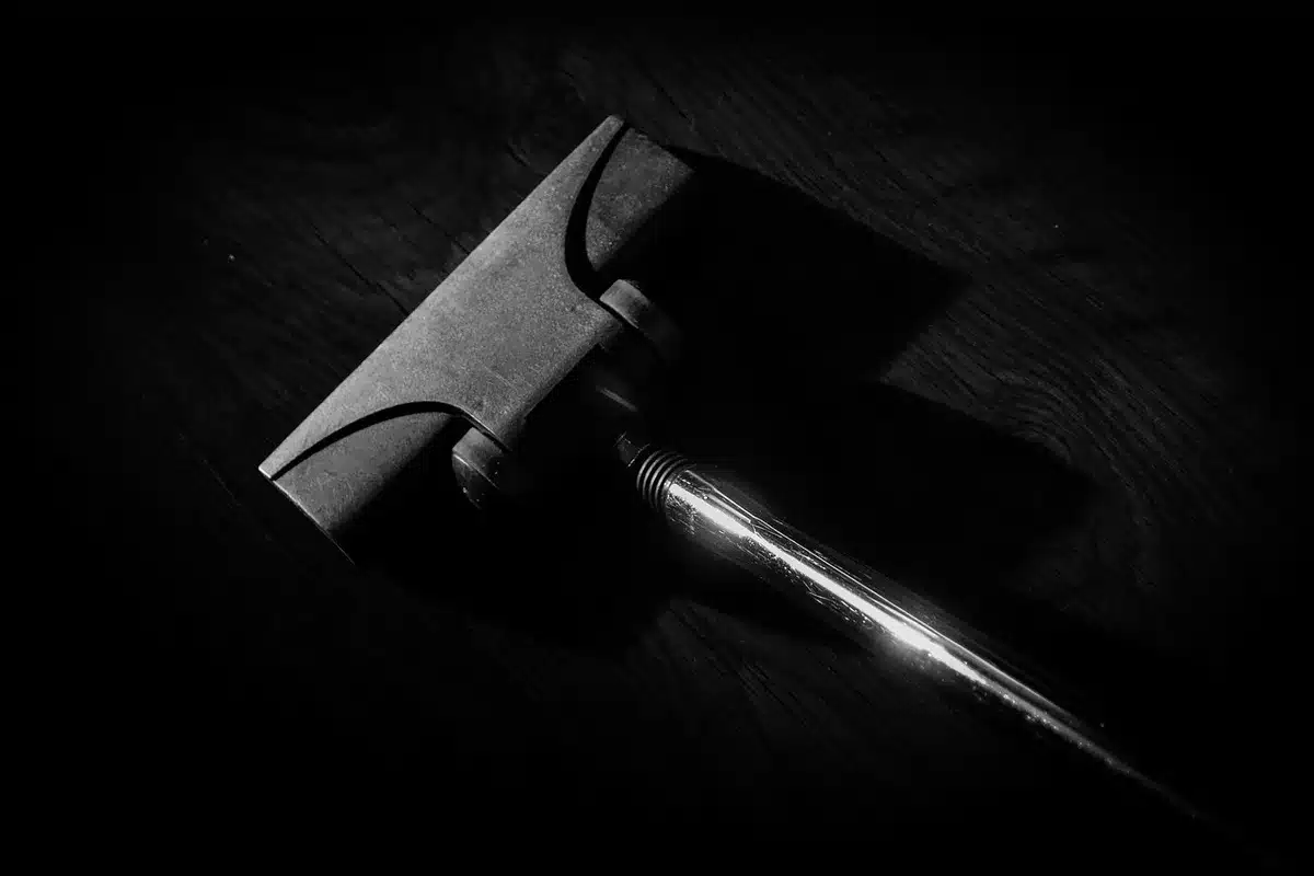 Handheld vacuum using crevice tool on upholstery and countertop