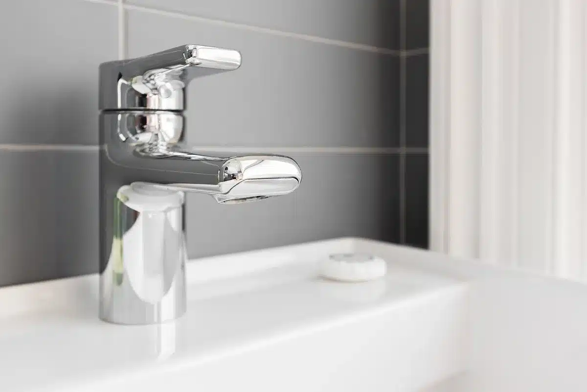 Close-up of a gleaming stainless steel sink with a buffed, reflective finish