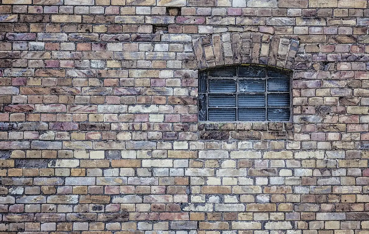 Samples of wood-look, brick-print, and floral peel-and-stick wallpaper finishes