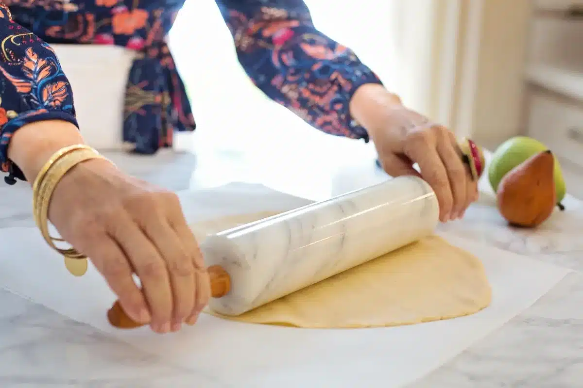 Vintage pie safe in a bright room with neatly folded towels inside
