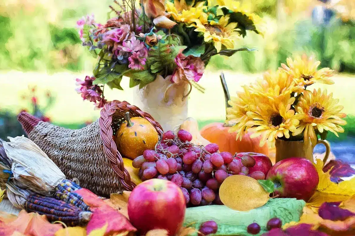 Table centerpiece made from cut pool noodle, faux flowers and a candle holder