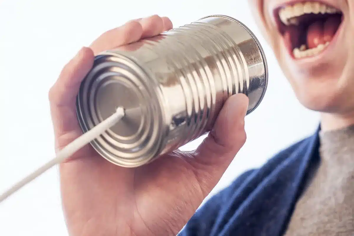 Stack of metal cans threaded on a central rod with spacers forming a rotating tower