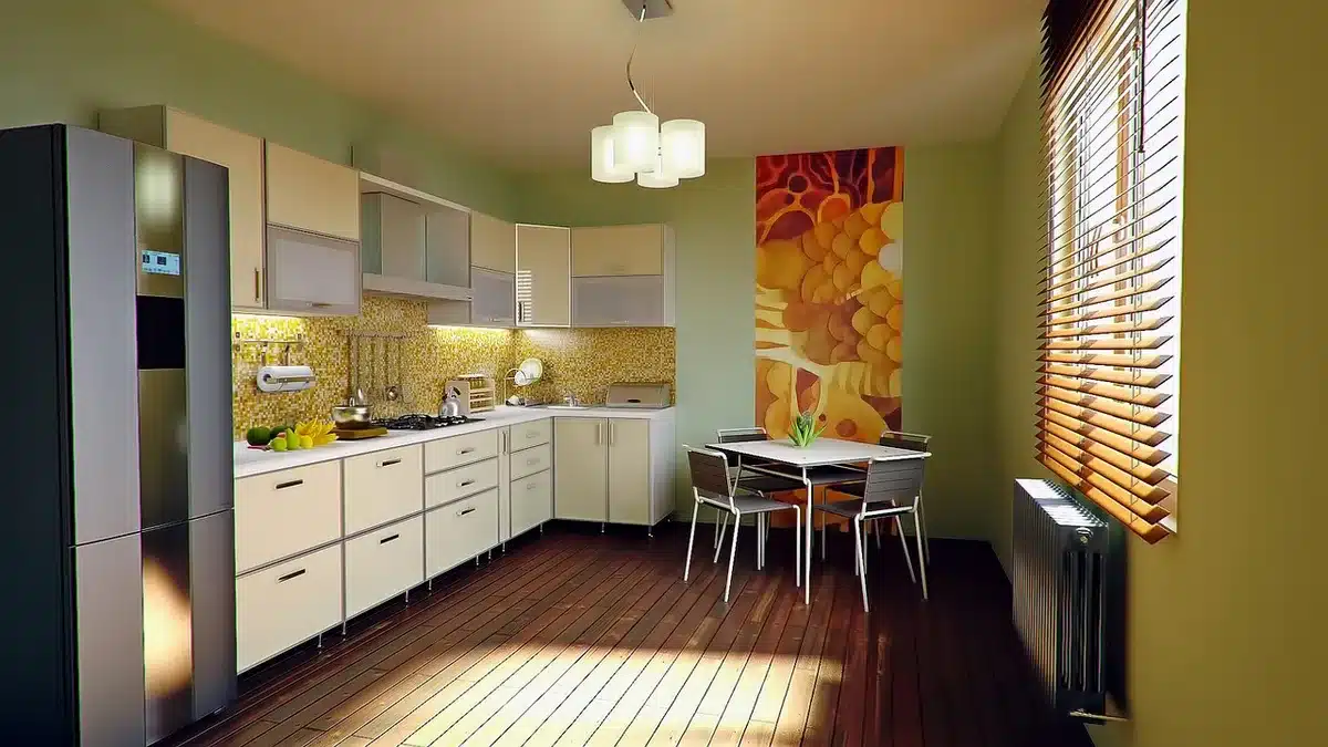 Sunlit kitchen showing a floral mosaic sheet being installed on a backsplash