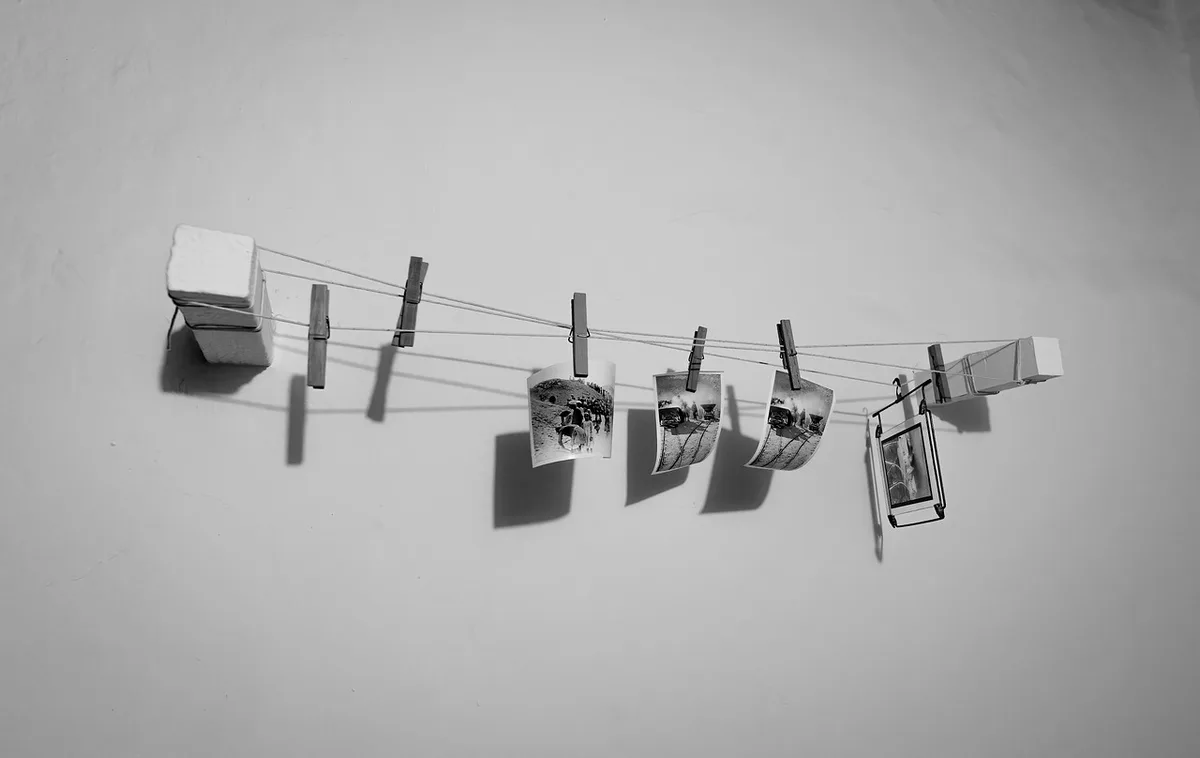 Handbags of different sizes hanging on an accordion wall rack