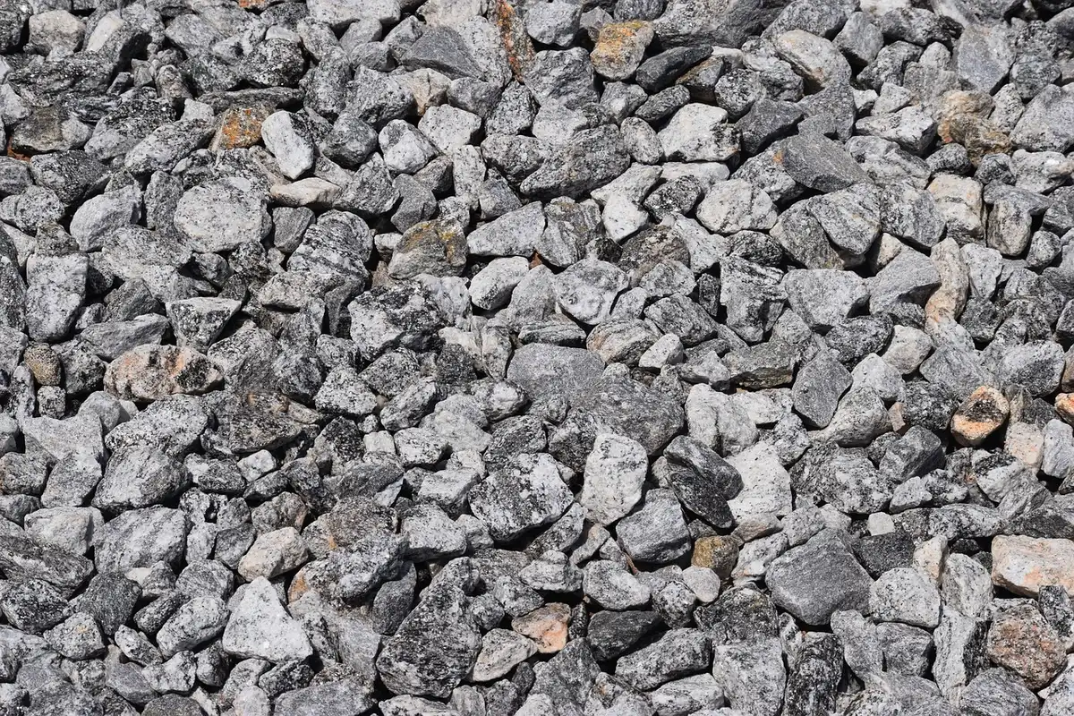 Preparing yard with compacted crushed-stone base and landscape fabric