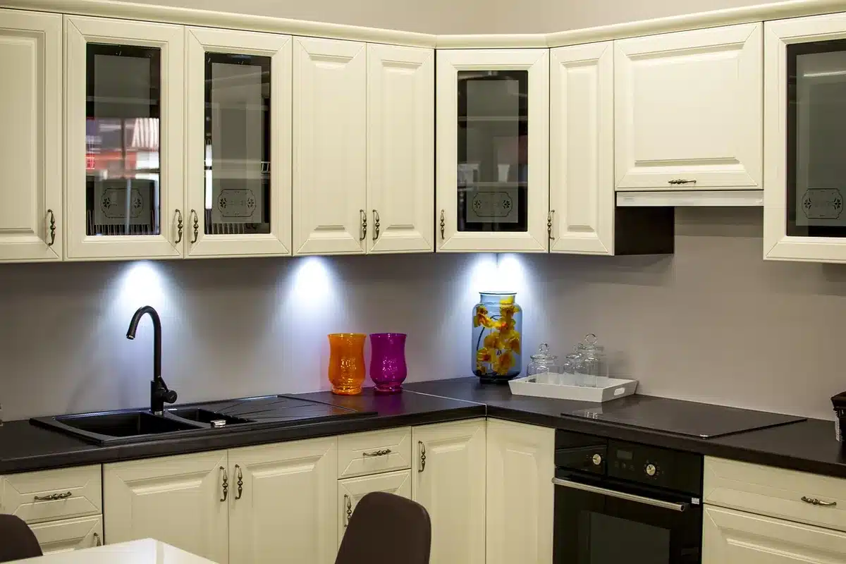 Kitchen sink area with whitewashed brick pavers used as a backsplash