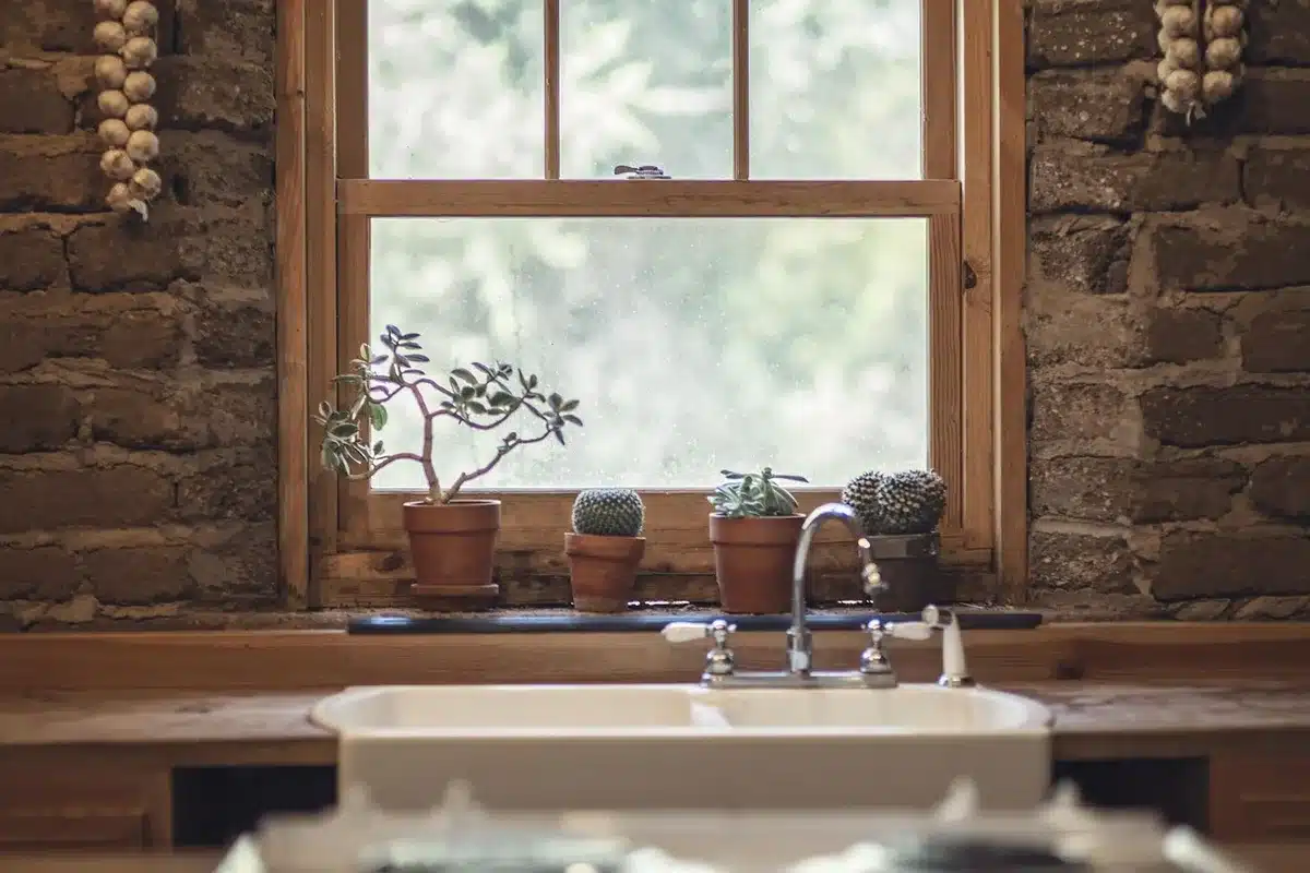 Kitchen island with sink, under-counter cabinets and stools in daylight
