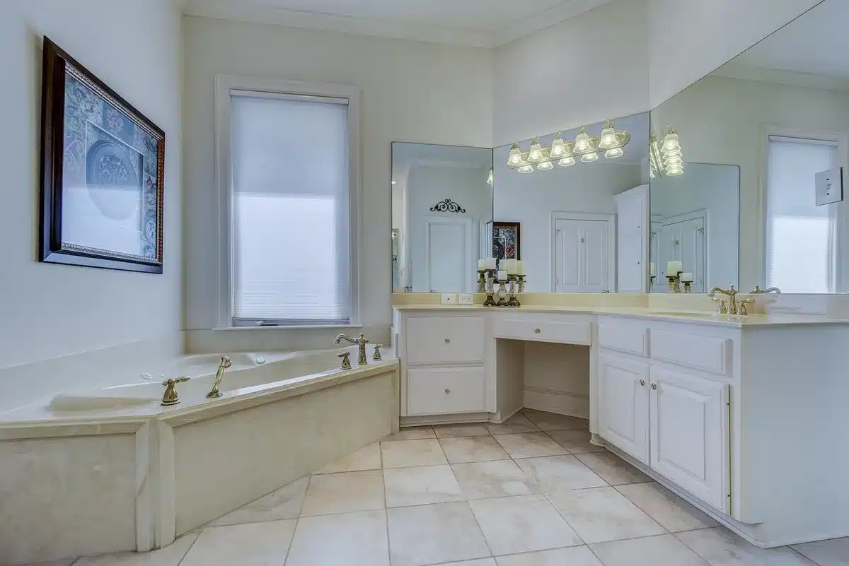 Bathroom floor showing herringbone marble tile layout with brass fixtures