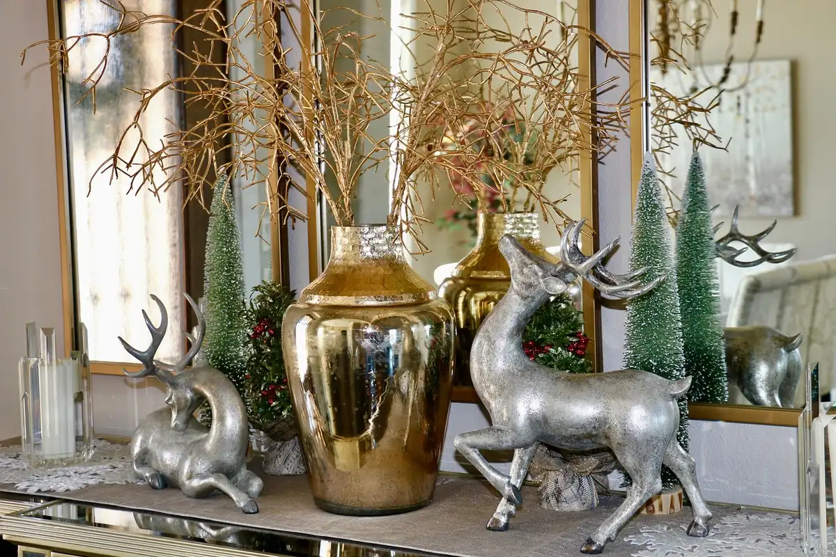 Matte gold reindeer figurines arranged on a bright mantel