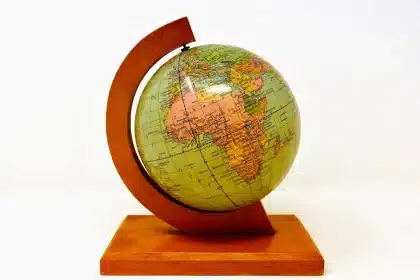 Vintage globe stand converted into a paper towel holder on a bright kitchen counter