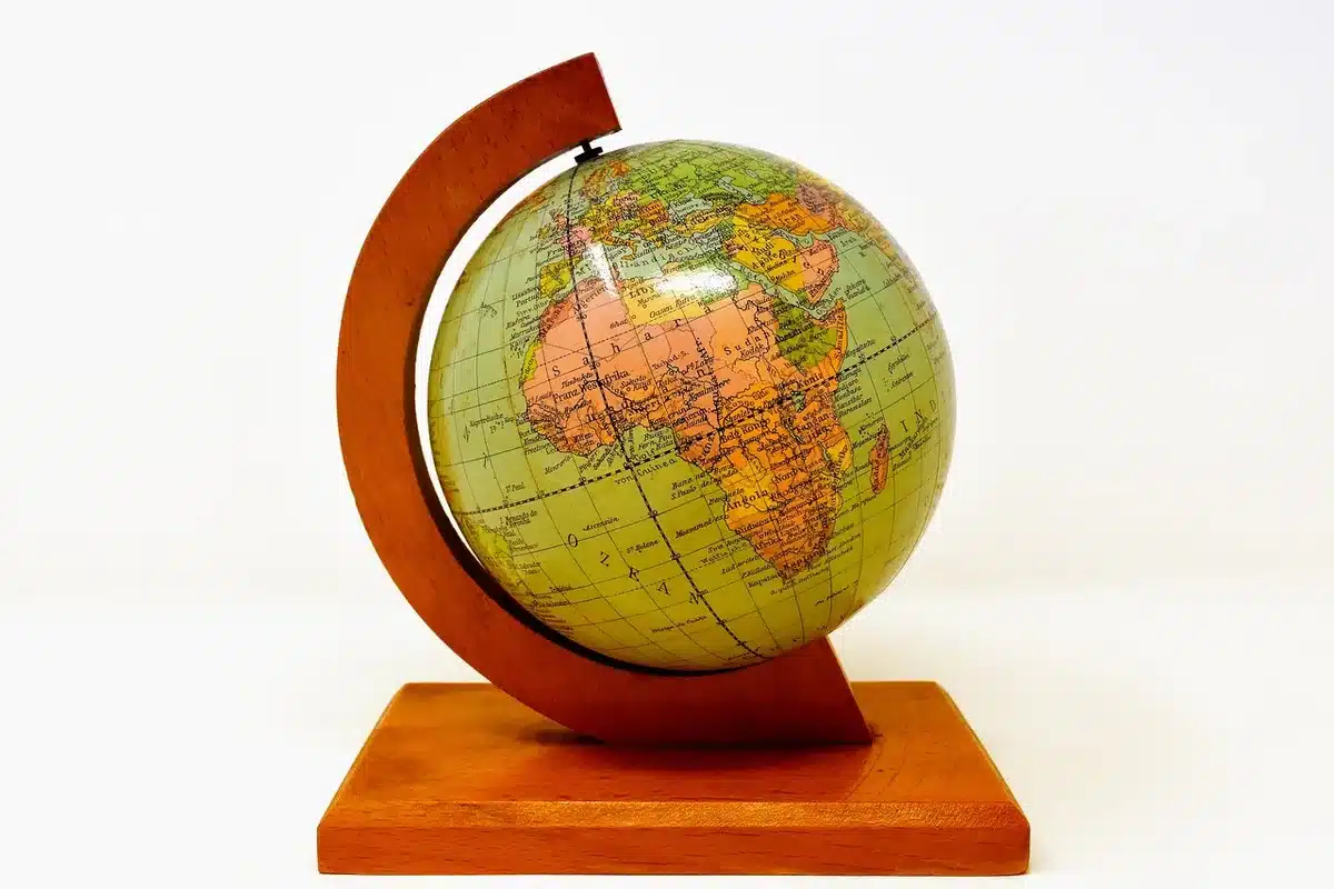 Vintage globe stand converted into a paper towel holder on a bright kitchen counter