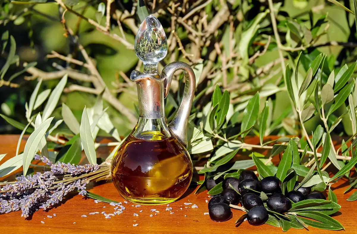 Countertop riser holding olive oil, salt and small bottles on a kitchen island
