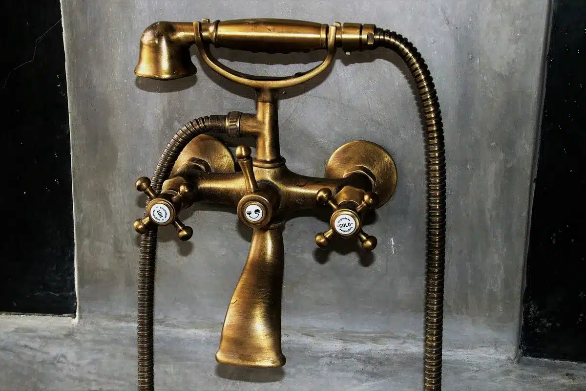 Hands fitting shower curtain hooks on a rod in a bright bathroom