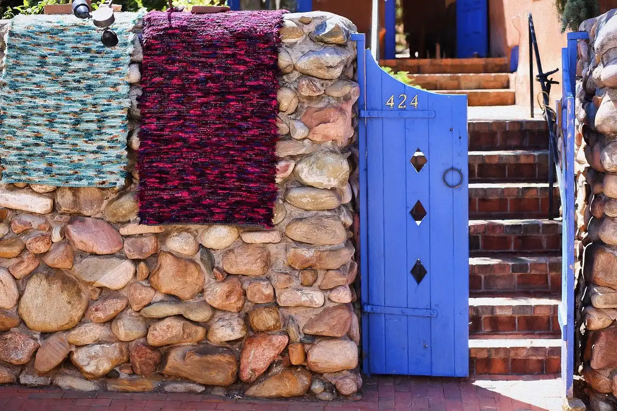 Colorful chindi rug folded as a hanging pouch on a front door