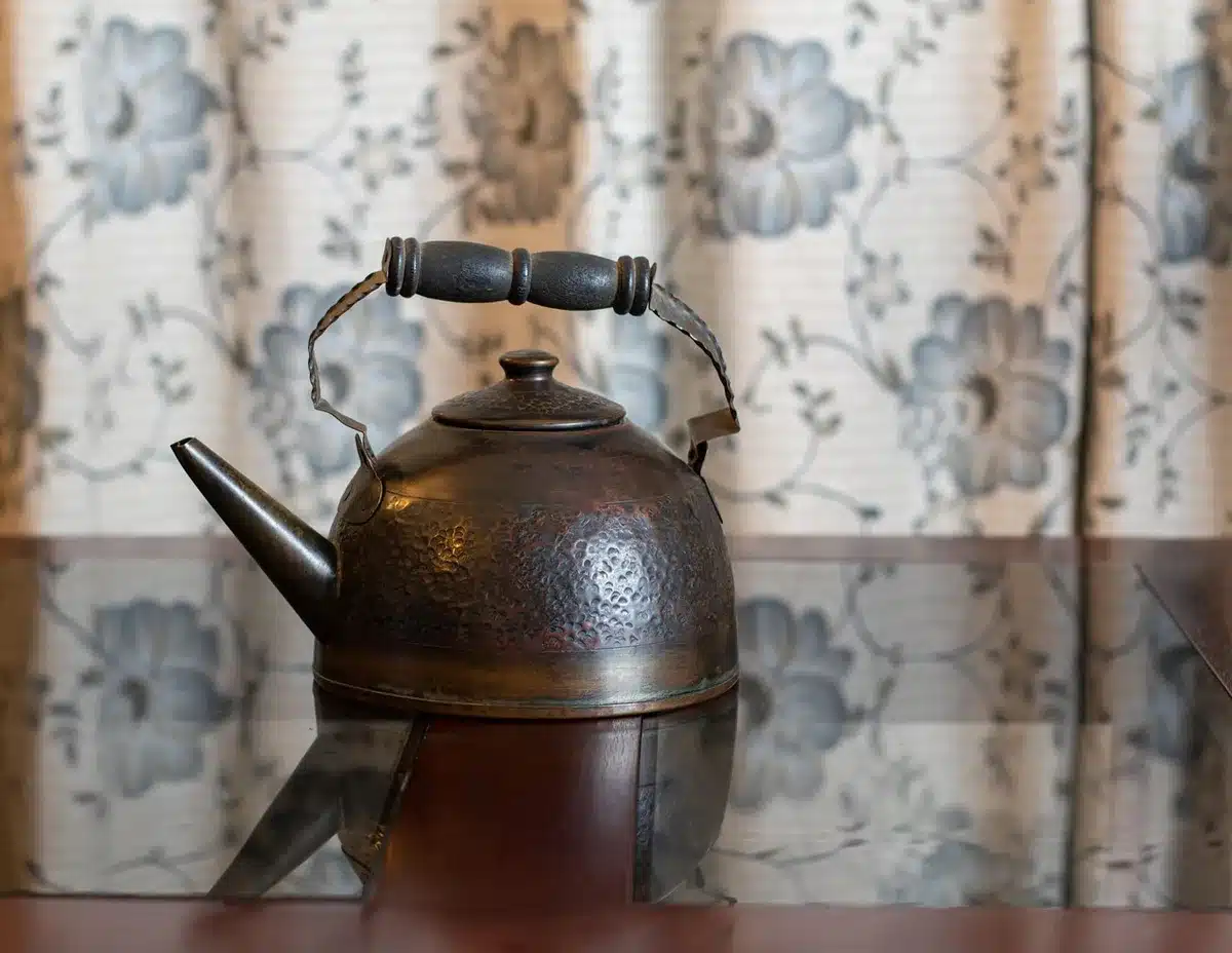 Close-up of a light-blue floral vintage teapot on a shelf