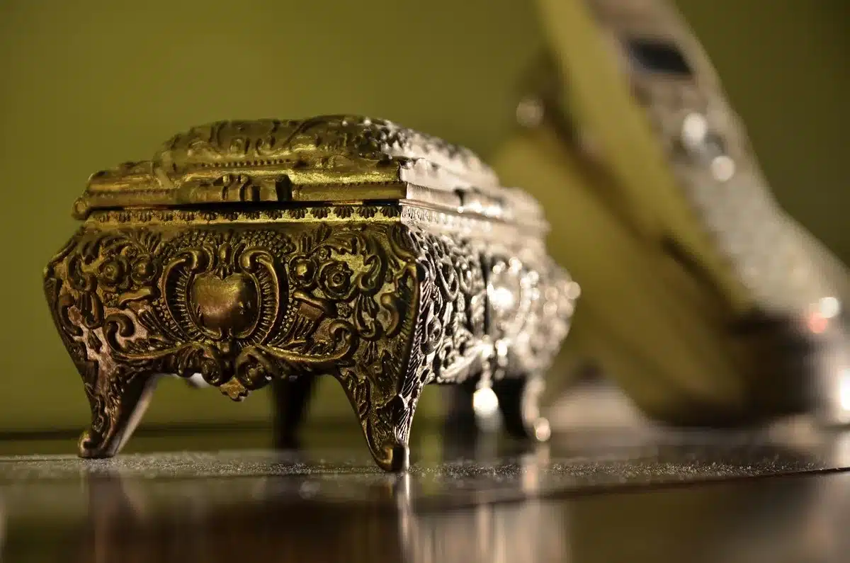 Close-up of a wooden jewelry box with shallow drawers holding soil and small plants