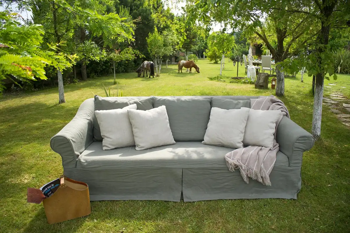 Sunlit patio with colorful outdoor throw pillows and a sewing kit on a chair